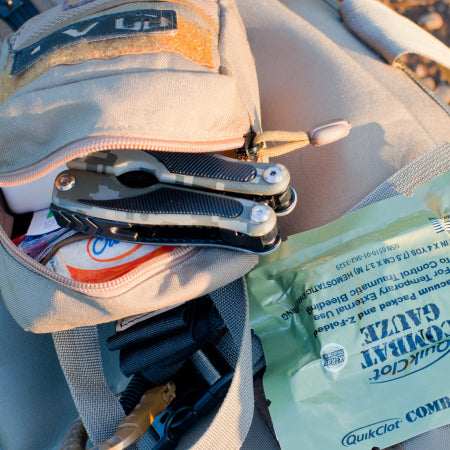 survival kit backpack with items pulled out