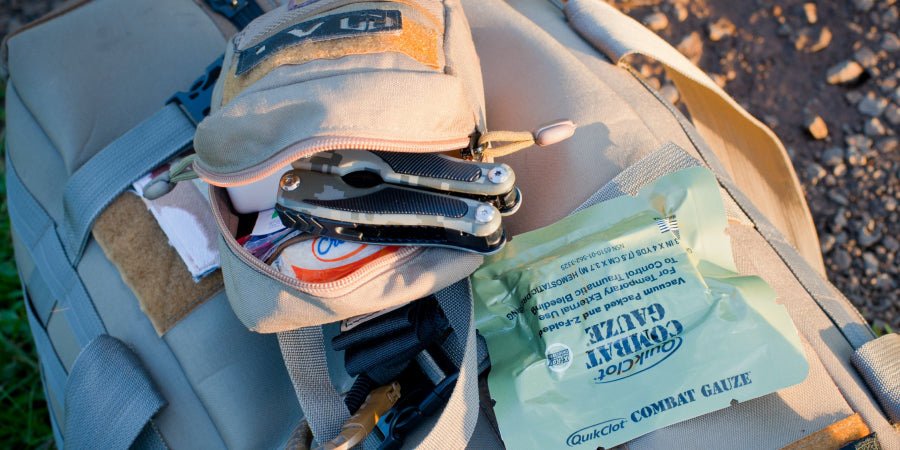 survival kit backpack with items pulled out