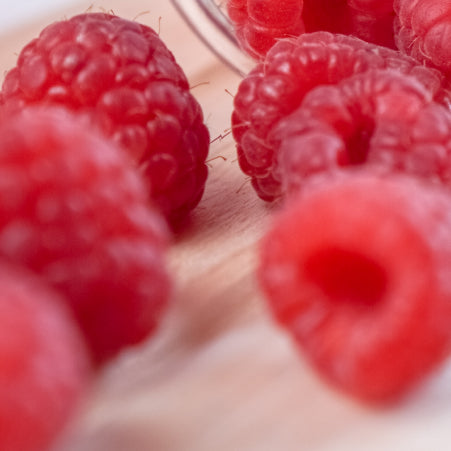 raspberries on cutting board