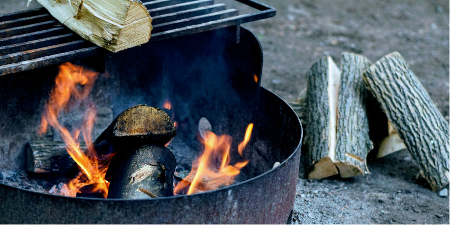 campfire in fire pit with grill for cooking