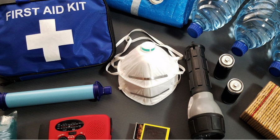 first aid kit backpack contents on a table