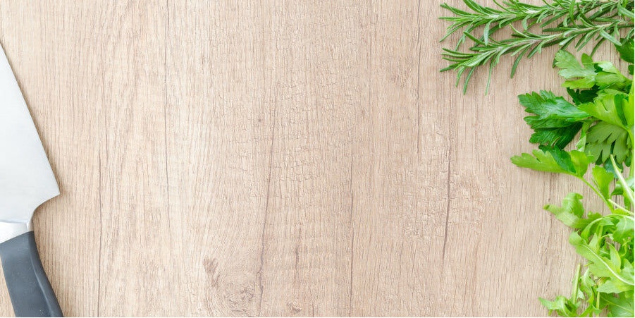 cutting board with knife and herbs