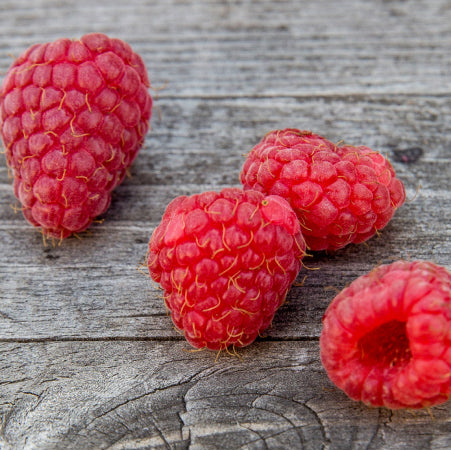 fresh raspberries on cutting board