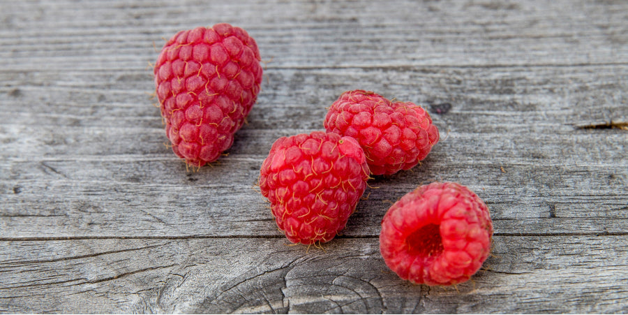 fresh raspberries on cutting board