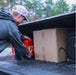 Man placing P72 disaster-proof bug out bag in the bed of a truck